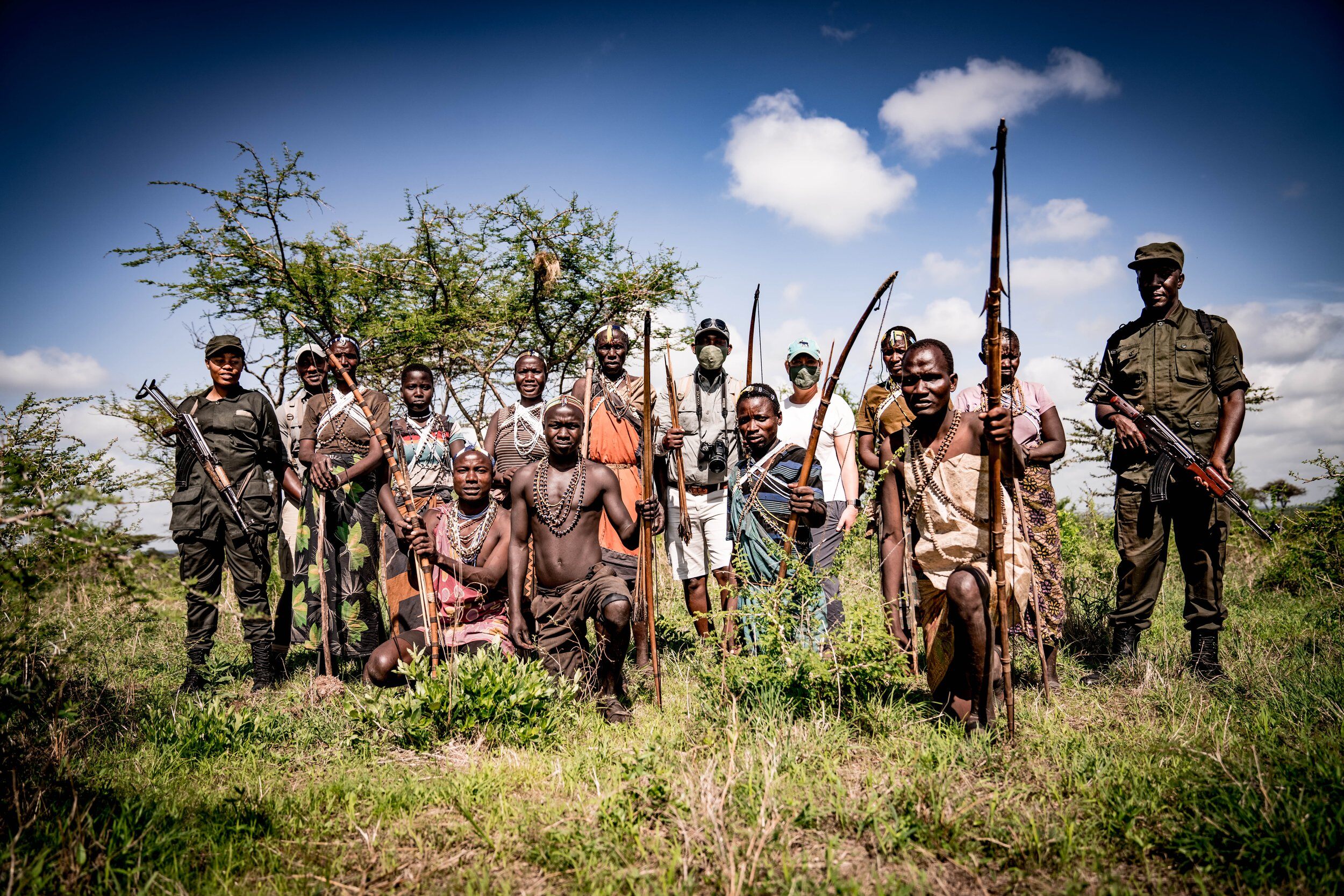 SafariSmiths Travel stands with a group of Hadzabe men